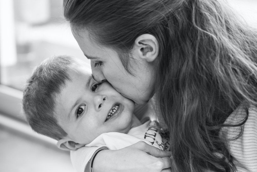 Mama en zoontje knuffelen