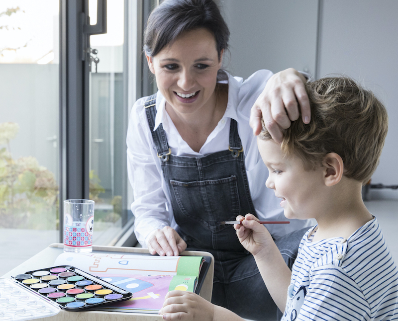 mama met zoontje dat schildert