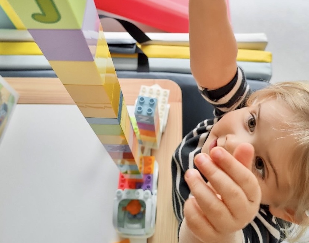 Meisje bouwt toren met DUPLO blokken
