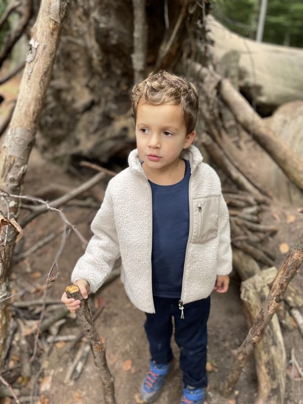 Jongetje met tak in het bos